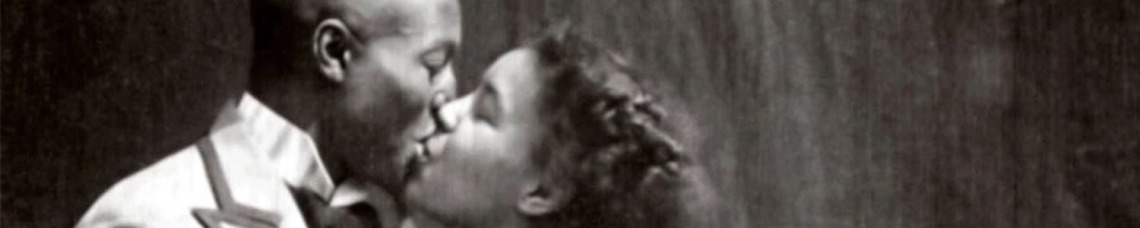 Vintage black and white photo of a male and female kissing