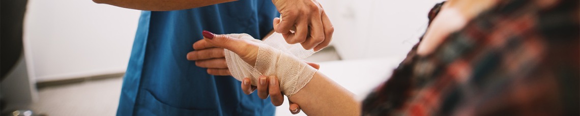 Nurse tending to patients' hand injury