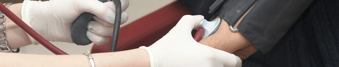 Nurse checking on patients pulse