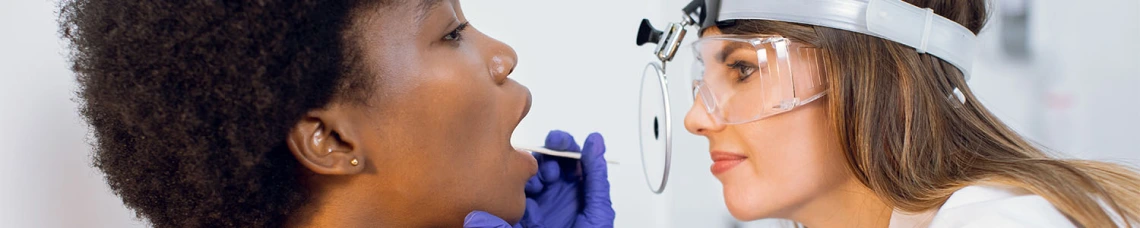 Nurse checking patients mouth