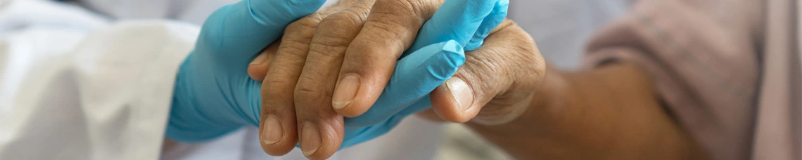 Nurse holding patients hand