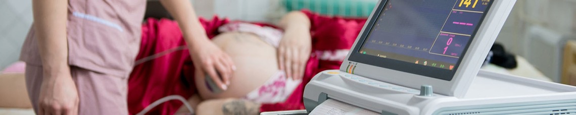 Nurse doing pregnant woman ultrasound