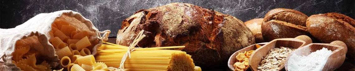Bread and dry pasta on table