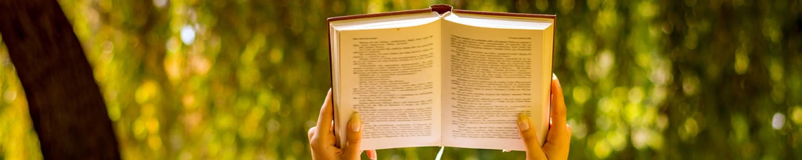Hands holding book open
